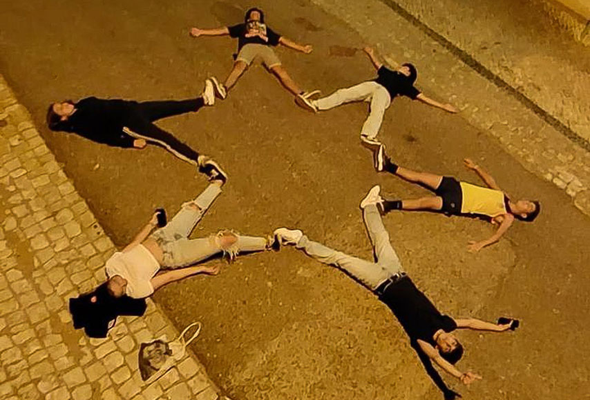 group of people laying down in star formation